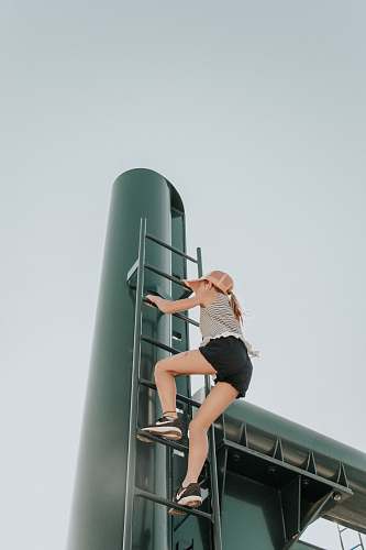 people woman climbing ladder person