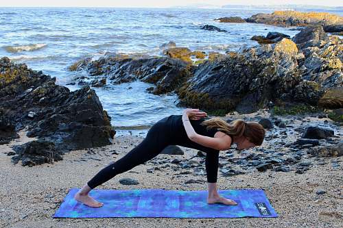 person woman doing yoga at beach sports