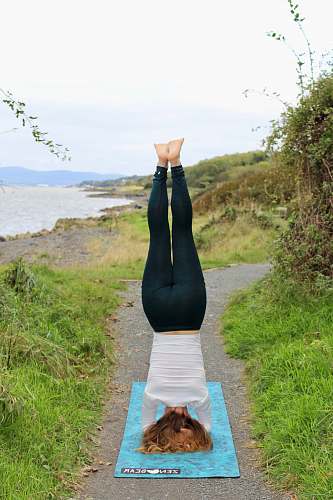 apparel woman doing yoga headstand person