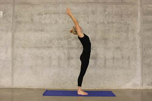 person woman doing yoga on yoga mat fitness
