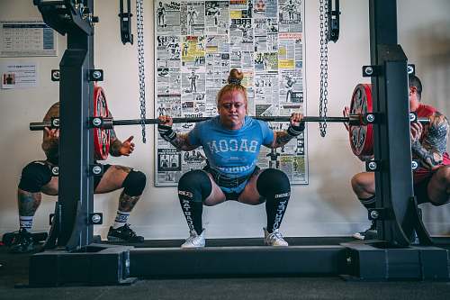 person woman holding barbell people