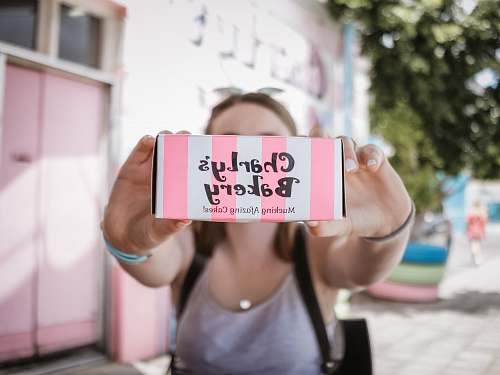 person woman holding Charly's Bakery box sports