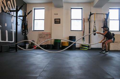 person woman holding exercise using training rope fitness