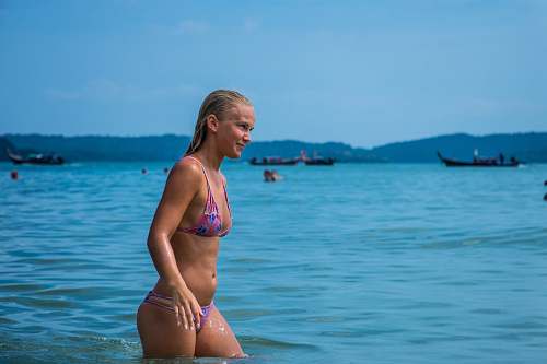 bikini woman in bikini standing in water during daytime swimwear