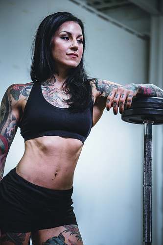 person woman leaning on black steel barbell people