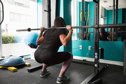 person woman lifting barbel rod sport