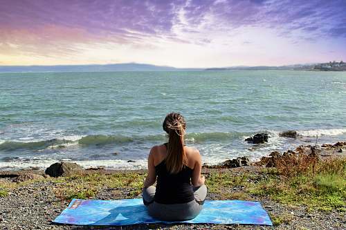 person woman meditating at beach exercise