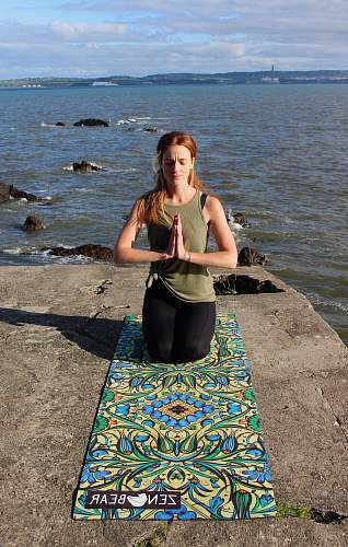 person woman praying on floral rug exercise