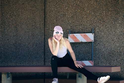 people woman sitting on brown bench person