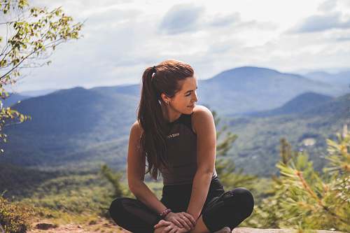 person woman sitting on ground outdoors