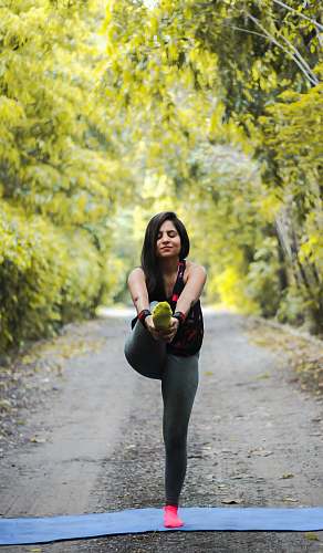 person woman standing and doing yoga vegetation