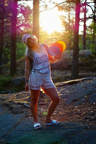 people woman standing and holding hand fans person