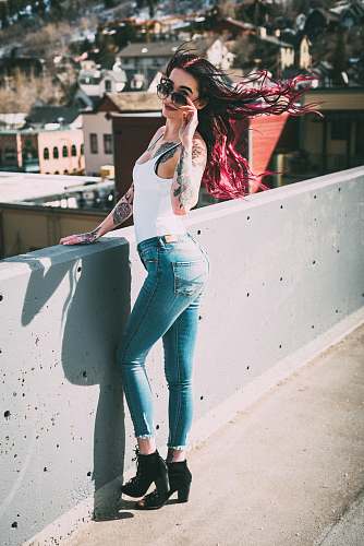 clothing woman standing near concrete rails pants