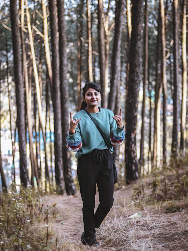 person woman standing near field of trees clothing