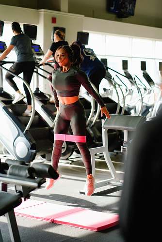 person woman standing near treadmill lot fitness