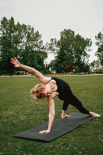 person woman stretching body on yoga mat exercise