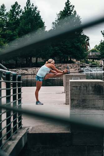 people woman stretching during daytime person