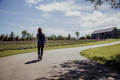 person woman walking in road outdoors
