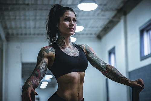 person woman wearing black sports bra with tattoos tattoo