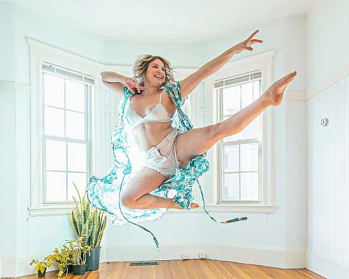 person woman wearing blue cardigan jumping dance