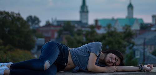 person woman wearing blue T-shirt and blue distressed jeans apparel