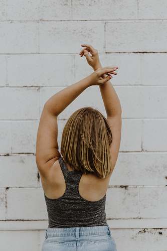 person woman wearing grey tank top apparel