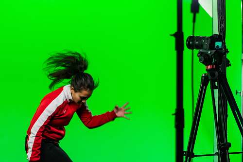 person woman wearing red and white track suit tripod