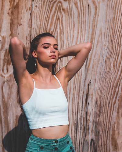 people woman wearing white camisole near wall person