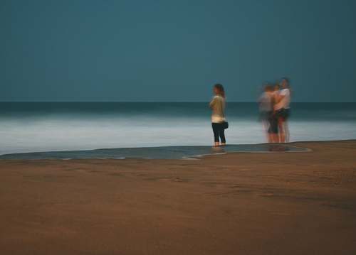 person women standing on seashore apparel