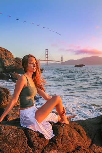 person women's gray camisole top and white skirt golden gate bridge