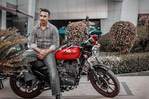 transportation man on a red and black motorcycle vehicle