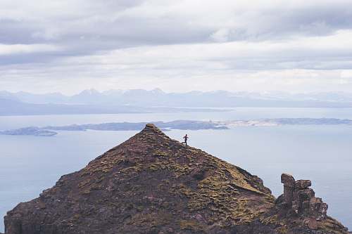 skye person walking on brown mountain peak