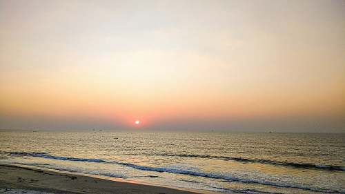 ocean body of water and sunrise outdoors