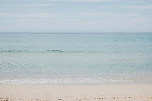 ocean calm waters at the shore grey