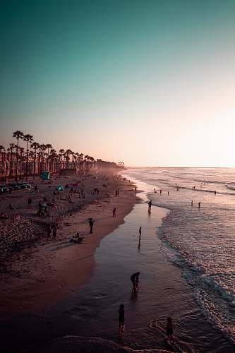 water people on shore during daytime ocean