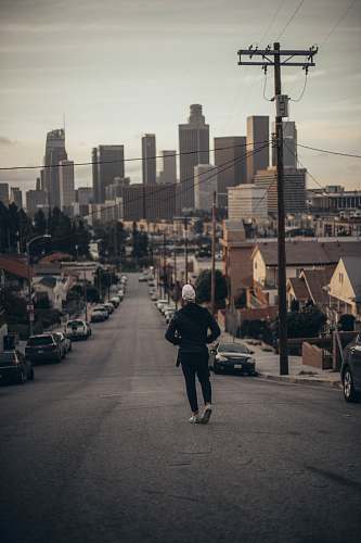 person man walking on road during daytime human