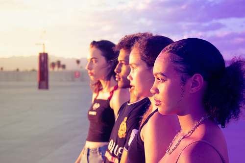 human four women standing on pathway looking side skin