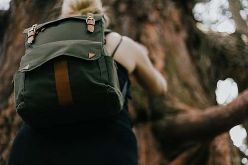 bag girl wearing green backpack climbing tree backpack