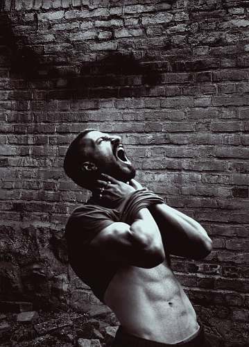 brick grayscale photo of man wall