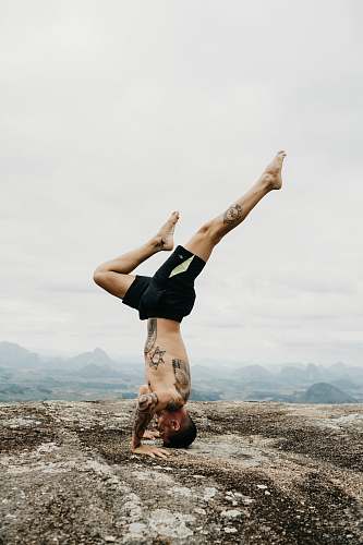 human man doing hand stand yoga
