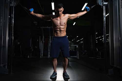 human man exercising inside dim room man