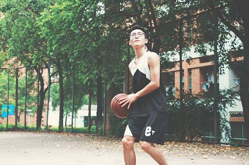 human man holding red basketball people