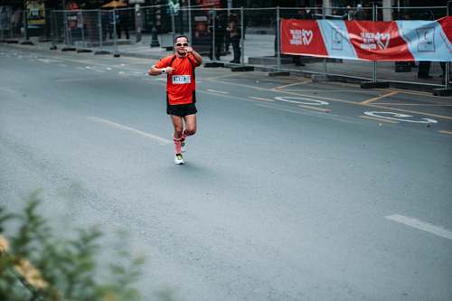 human man in red jersey running clothing