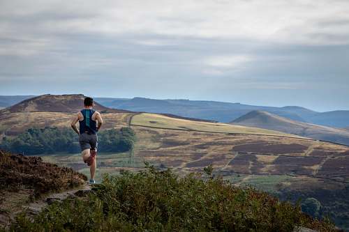 human man running on mountain outdoors