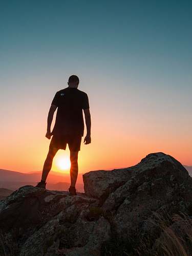 human man standing on boulder people