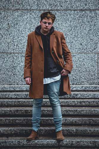 human man standing on gray concrete stairs people