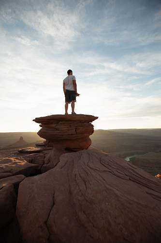 human man standing on peak people