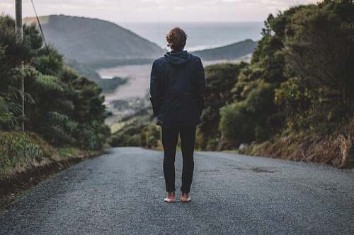 people man standing on road near river nature