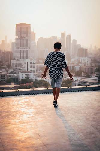 human man standing on rooftop people