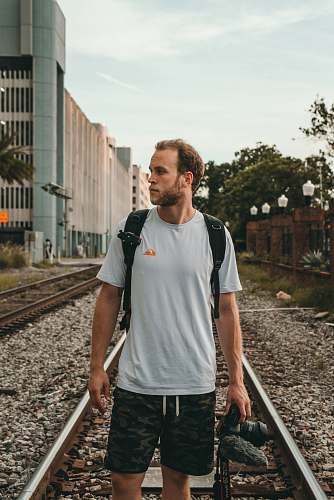 people man standing on train rail at daytime train track
